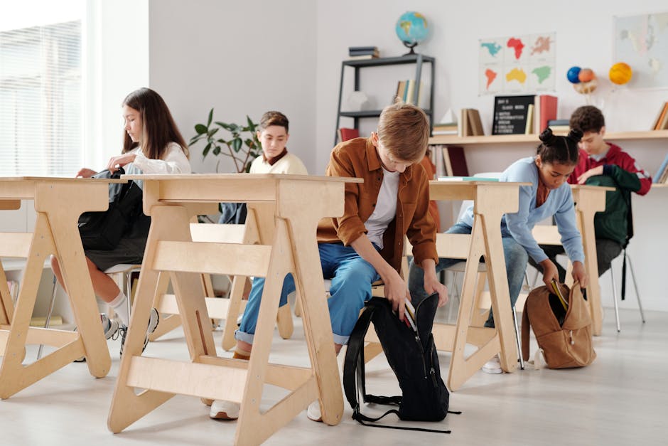 Teen students organizing backpacks in a bright classroom setting